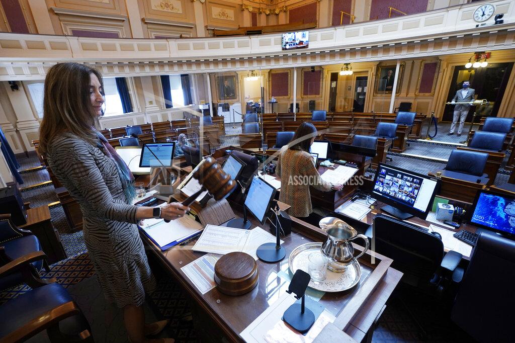 Steve Helber House speaker Del. Eileen Filler-Corn, D-Fairfax, gavels in the session to an empty Virginia House of Delegates chamber after a Zoom Legislative session at the Capitol in Richmond, Va., Wednesday, Feb. 10, 2021. (AP Photo/Steve Helber)