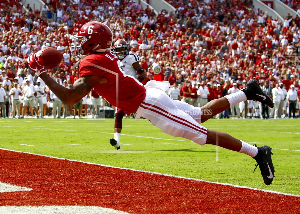 FILE - In this Sept. 22, 2018, file photo, Alabama wide receiver DeVonta Smith (6) catches a pass for a touchdown during the first half of an NCAA college football game against Texas A&M, in Tuscaloosa, Ala. No. 1 Alabama has one of the SEC's most talented collection of receivers, and the Crimson Tide is spreading it around among Jerry Jeudy, Henry Ruggs III, DeVonta Smith and Jaylen Waddle. (AP Photo/Butch Dill, File)