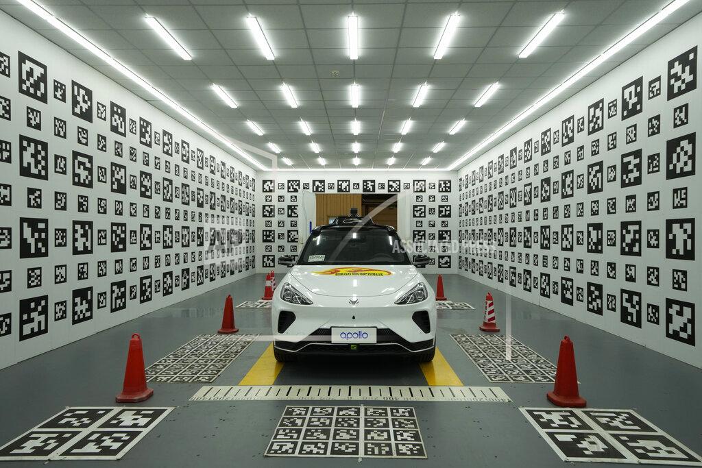 Ng Han Guan A self-driving taxi developed by tech giant Baidu Inc. is seen in a chamber used to calibrate its sensors, on June 14, 2022, in Beijing. Baidu Inc. is China's highest-profile competitor in a multibillion-dollar race with Alphabet Inc.'s Waymo and General Motors Co.'s Cruise to create self-driving cars. (AP Photo/Ng Han Guan)
