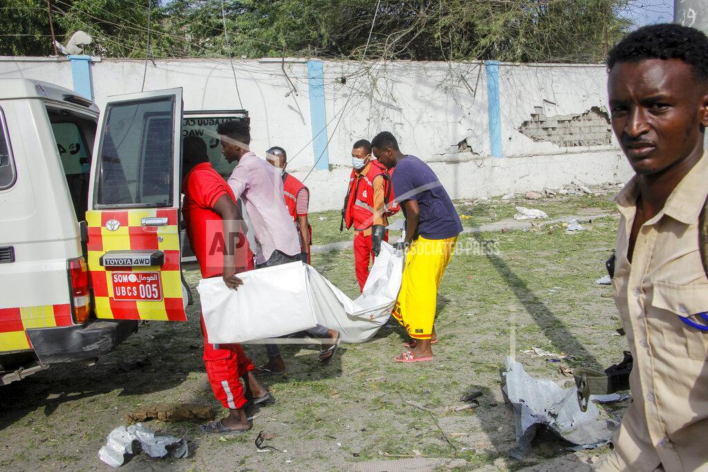 Farah Abdi Warsameh Rescue workers carry away the body of a civilian who was killed in a blast in Mogadishu, Somalia Thursday, Nov. 25, 2021. Witnesses say a large explosion has occurred in a busy part of Somalia's capital during the morning rush hour. (AP Photo/Farah Abdi Warsameh)