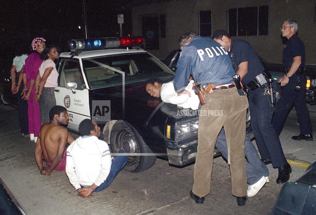 Douglas C. Pizac FILE - In this April 9, 1988, file photo, Los Angeles police officers search one of seven people arrested for selling narcotics in the south-central area of Los Angeles, as more than 1,000 police officers raided gang strongholds to attack on drug dealing and street violence in the nation's second largest city. In 1971, President Richard Nixon declared a war on drugs. It is questionable whether anyone won the war. Who suffered the worst losses is clearer: Black Americans, their families and their communities. (AP Photo/Douglas C. Pizac, File)