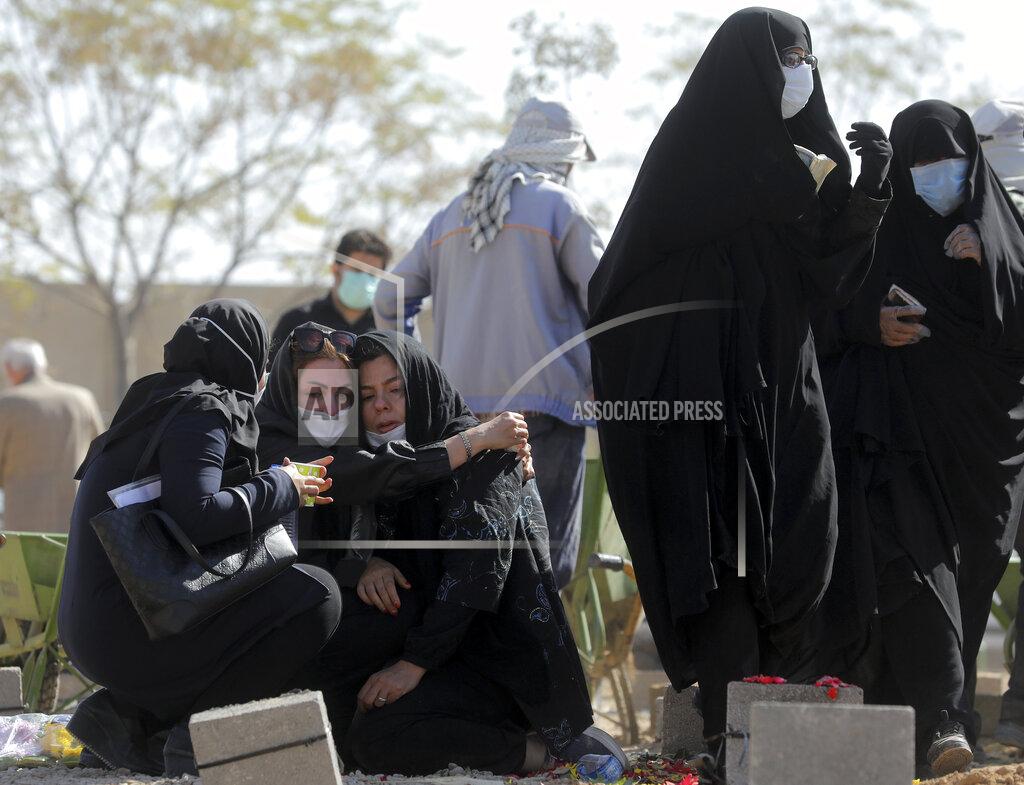 Ebrahim Noroozi Mourners attend the funeral of a person who died from COVID-19 at the Behesht-e-Zahra cemetery just outside Tehran, Iran, Sunday, Nov. 1, 2020. (AP Photo/Ebrahim Noroozi)