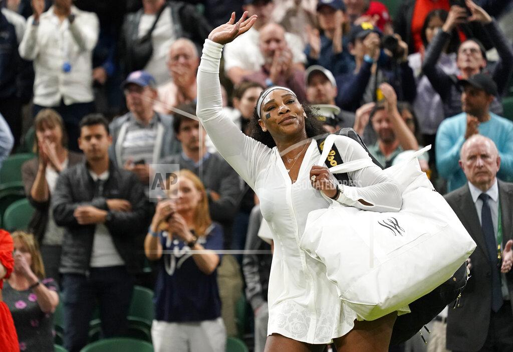 Alberto Pezzali Serena Williams of the US waves as she leaves the court after losing to France's Harmony Tan in a first round women's singles match on day two of the Wimbledon tennis championships in London, Tuesday, June 28, 2022. (AP Photo/Alberto Pezzali)