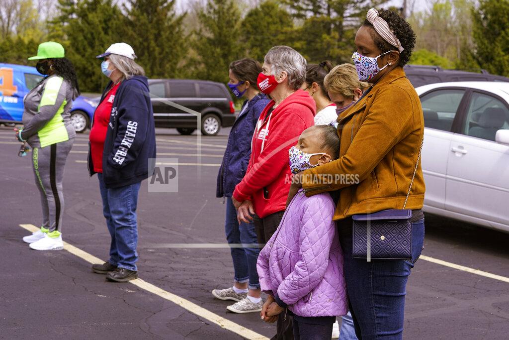 Michael Conroy People gather for a prayer during a vigil at the Missionary Baptist Church in Indianapolis, Saturday, April 17, 2021 for the victims of the shooting at a FedEx facility. A gunman killed eight people and wounded several others before taking his own life in a late-night attack at a FedEx facility near the Indianapolis airport, police said. (AP Photo/Michael Conroy)
