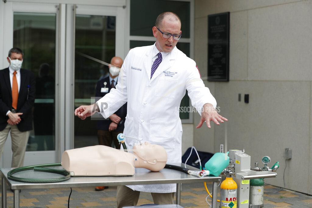 Rogelio V. Solis Dr. Charles Robertson, an assistant professor of anesthesiology at the University of Mississippi Medical Center shows the simple "last resort" ventilator he and a group of pediatric nurses and physicians designed and built in Jackson, Miss., Tuesday, April 7, 2020. The group has built and tested 170 Robertson Ventilators made of items such as tubing, garden hose, and a digital timer found at local hardware stores. The medical school hopes to fast track approval by the U.S. Food and Drug Administration so they can be put into use should they be needed. (AP Photo/Rogelio V. Solis)