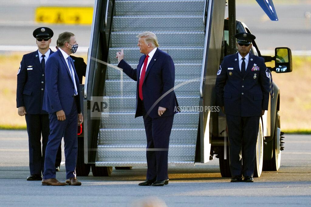 Charles Krupa President Donald Trump is greeted by New Hampshire Gov. Chris Sununu, left, as he arrives for a campaign rally at Manchester-Boston Regional Airport, Friday Aug. 28, 2020 in Londonderry, N.H. President Trump easily won the February New Hampshire Republican primary. (AP Photo/Charles Krupa, File)
