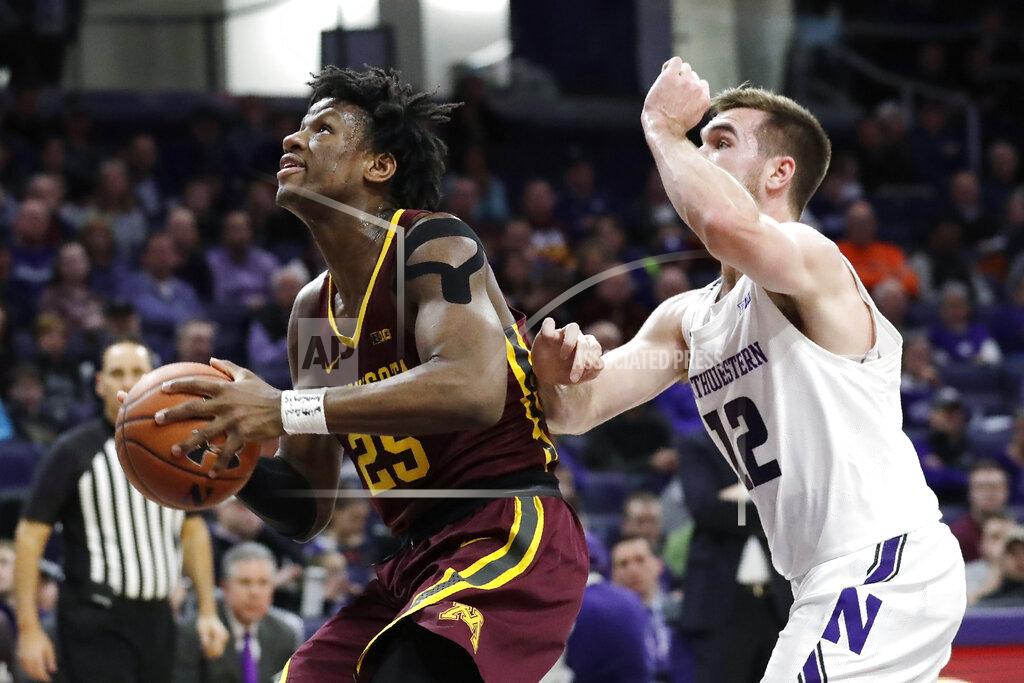 Nam Y. Huh Minnesota center Daniel Oturu, left, drives to the basket past Northwestern guard Pat Spencer during the first half of an NCAA college basketball game in Evanston, Ill., Sunday, Feb. 23, 2020. (AP Photo/Nam Y. Huh)