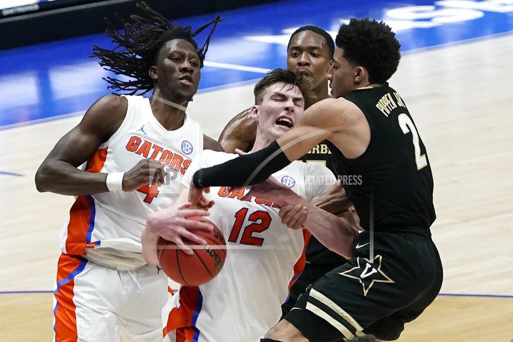 Mark Humphrey Vanderbilt's Trey Thomas (12) battles for the rebound with Vanderbilt's Scotty Pippen Jr. (2) in the second half of an NCAA college basketball game in the Southeastern Conference Tournament Thursday, March 11, 2021, in Nashville, Tenn. (AP Photo/Mark Humphrey)