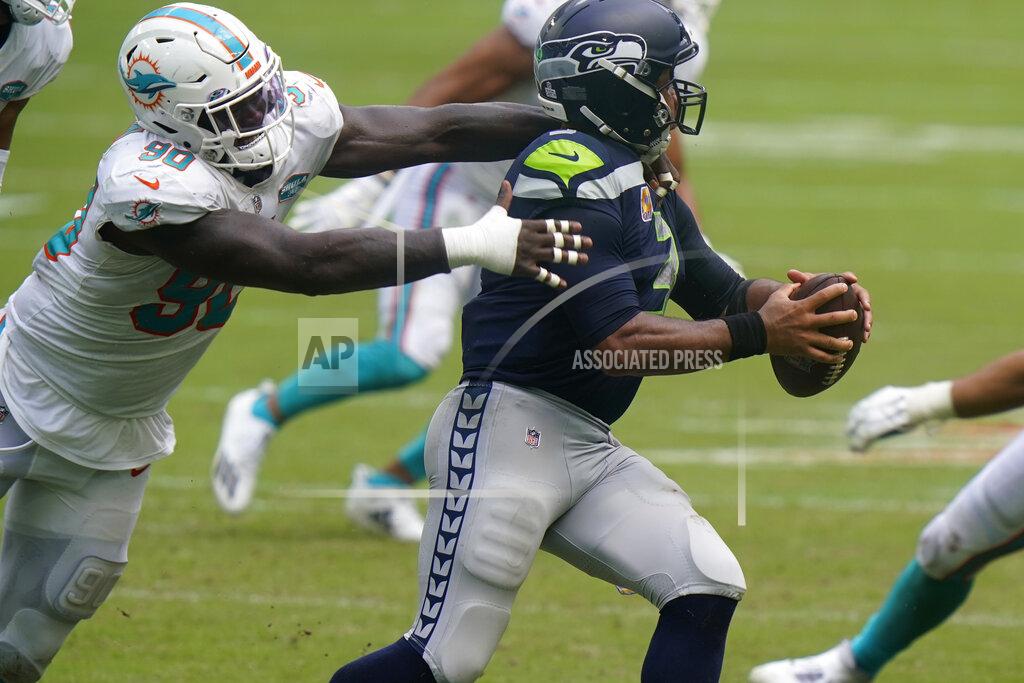 Lynne Sladky Miami Dolphins defensive end Shaq Lawson (90) sacks Seattle Seahawks quarterback Russell Wilson (3), during the second half of an NFL football game, Sunday, Oct. 4, 2020, in Miami Gardens, Fla. (AP Photo/Lynne Sladky)