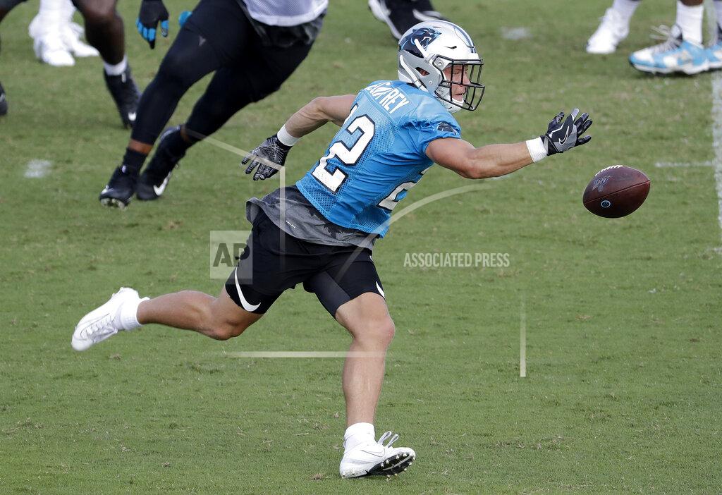 Chuck Burton Carolina Panthers' Christian McCaffrey (22) reaches in vain for a catch during practice at the NFL football team's training camp in Spartanburg, N.C., Friday, July 26, 2019. (AP Photo/Chuck Burton)