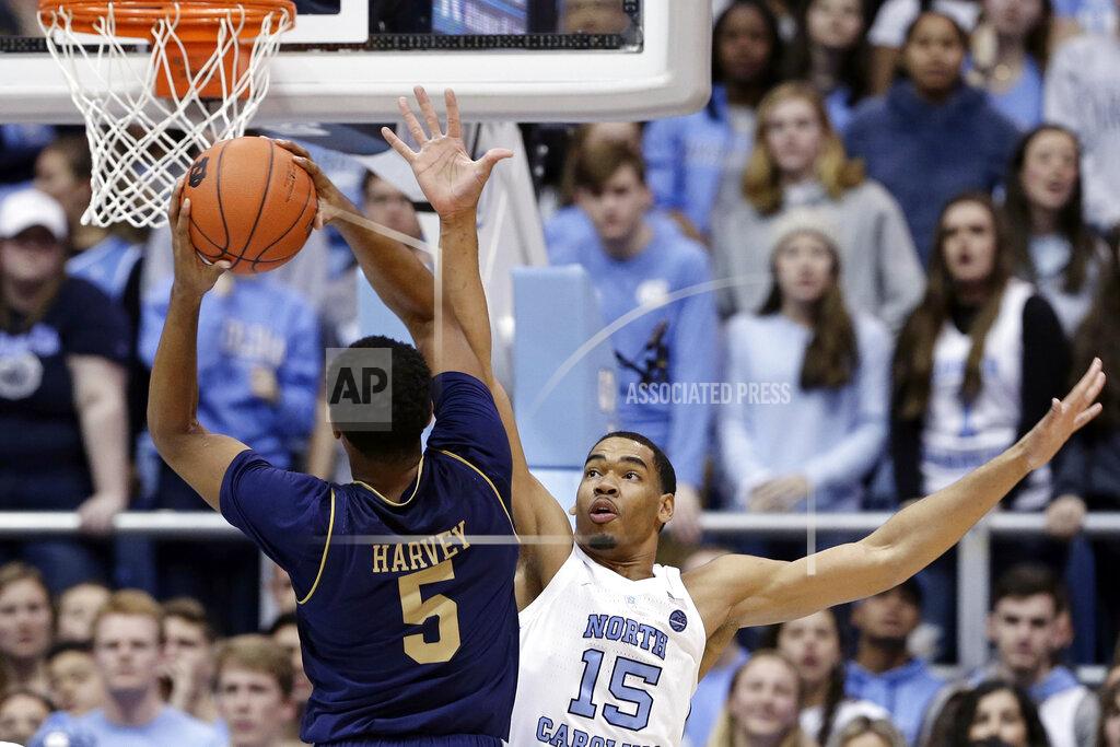 Gerry Broome North Carolina's Garrison Brooks (15) defends as Notre Dame's D.J. Harvey (5) shoots during the first half of an NCAA college basketball game in Chapel Hill, N.C., Tuesday, Jan. 15, 2019. (AP Photo/Gerry Broome)