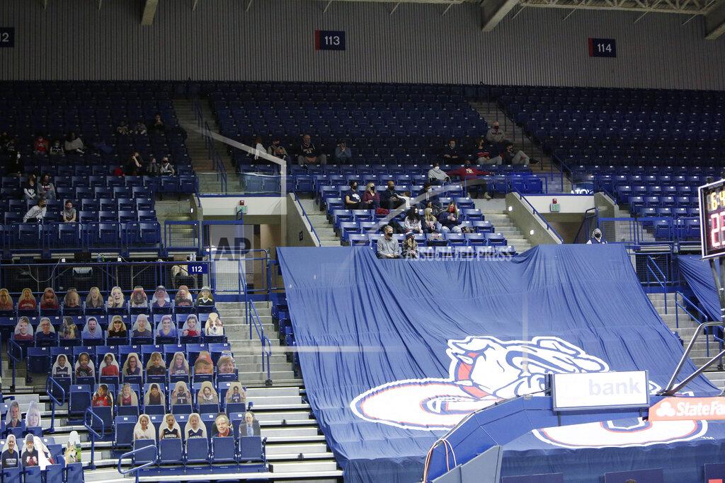 Young Kwak Players' families, top, the first fans allowed to watch a game at the McCarthey Athletic Center this season due to the COVID-19 pandemic, watch the first half of an NCAA college basketball game between Gonzaga and Saint Mary's in Spokane, Wash., Thursday, Feb. 18, 2021. (AP Photo/Young Kwak)