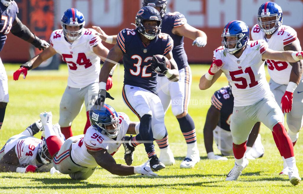 Brian Cassella Chicago Bears running back David Montgomery (32) runs against New York Giants linebacker Kyler Fackrell (51) in the fourth quarter of an NFL football game Sunday, Sept. 20, 2020, in Chicago. (Brian Cassella/Chicago Tribune via AP)