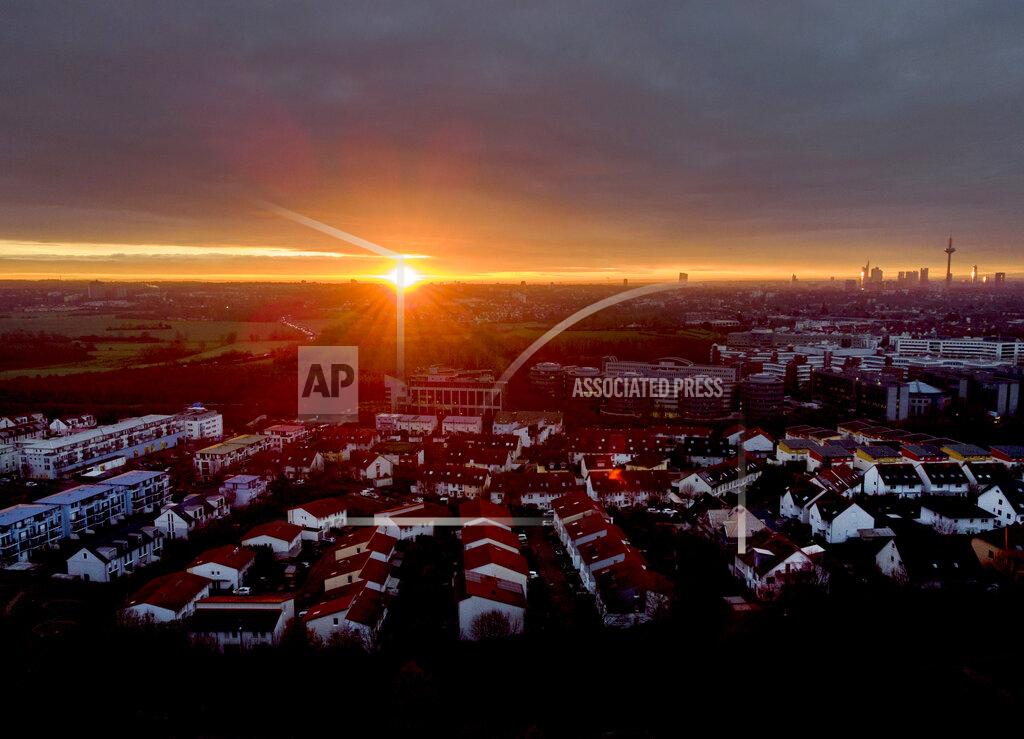 Michael Probst The sun rises over Frankfurt, Germany, Monday, Dec. 14, 2020. Germany goes into a lockdown on Wednesday, Dec. 16, 2020. (AP Photo/Michael Probst)
