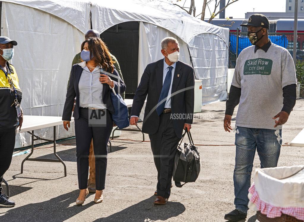 Damian Dovarganes FILE - In this Feb. 4, 2021, file photo, Jeff Page, right, also known as General Jeff, a homelessness activist and leader in the Downtown Los Angeles Skid Row Neighborhood Council, walks with U.S. District Court Judge David O. Carter, middle, and Michele Martinez, special master on the issues of homelessness, after a court hearing at Downtown Women's Center in Los Angeles. A judge overseeing a sweeping lawsuit about homelessness in Los Angeles has ordered the city and county Tuesday, April 20, 2021, to find shelter for all unhoused residents of Skid Row within 180 days. Judge David O. Carter also ordered an audit of all funding related to the crisis of people living on the streets. (AP Photo/Damian Dovarganes, File)