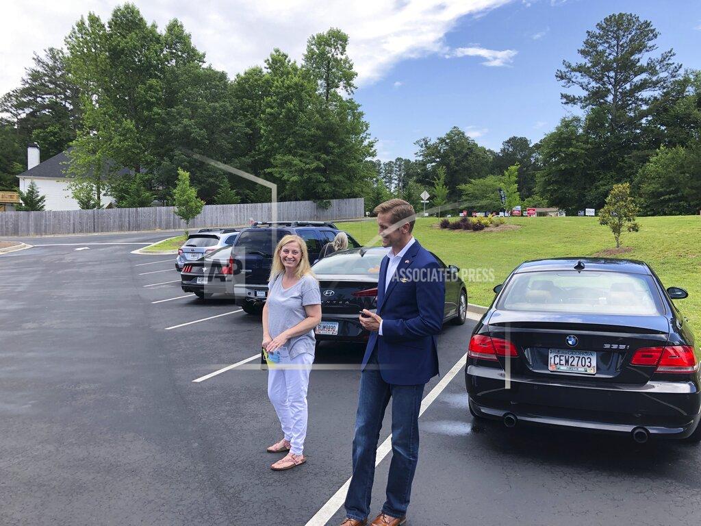 Jeff Amy Republican congressional candidate Rich McCormick talks to a neighbor outside a precinct at North Gwinnett Church in Suwannee, Ga., on Tuesday, June 9, 2020. McCormick, an emergency room physician making his first run for office, is running in suburban Atlanta's 7th Congressional District, expected to be one of districts most closely contested between the major parties this fall (AP Photo/Jeff Amy)