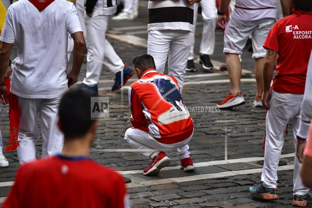 Alvaro Barrientos People wait for the start on the first day of the running of the bulls at the San Fermin Festival in Pamplona, northern Spain, Thursday, July 7, 2022. Revelers from around the world flock to Pamplona every year for nine days of uninterrupted partying in Pamplona's famed running of the bulls festival which was suspended for the past two years because of the coronavirus pandemic. (AP Photo/Alvaro Barrientos)