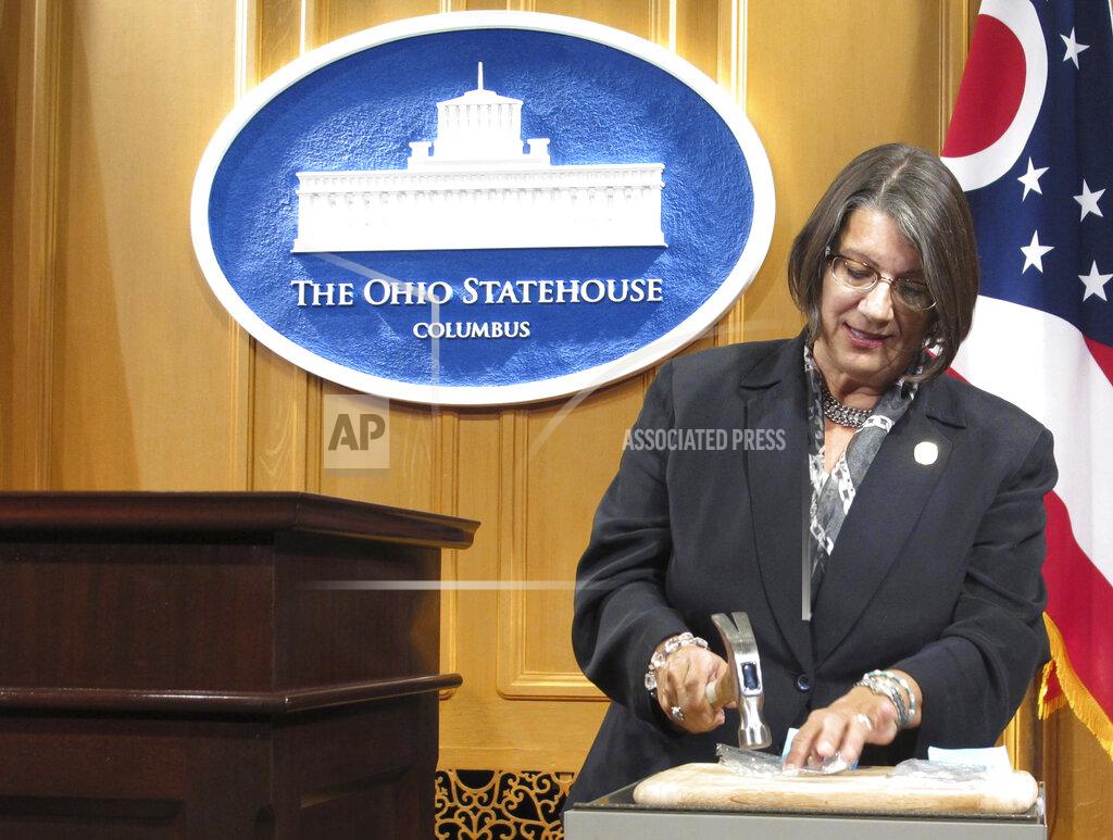 FILE - In this Sept. 17, 2015, file photo, Ohio state Rep. Nickie Antonio, a Democrat from Lakewood in suburban Cleveland, demonstrates tamper-resistant pain pills during a news conference in Columbus, Ohio. Antonio is a sponsor of legislation banning the death penalty that has the support of some Senate Republicans. She said Friday, Nov. 13, 2020, that a death penalty ban is the compassionate, pragmatic and economically prudent thing to do. (AP Photo/Andrew Welsh-Huggins, File)