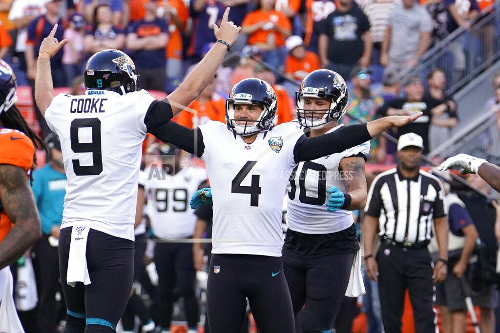 Jack Dempsey Jacksonville Jaguars kicker Josh Lambo (4) celebrates with teammate holder Logan Cooke (9) after making a game-winning field goal during the second half of an NFL football game against the Denver Broncos, Sunday, Sept. 29, 2019, in Denver. (AP Photo/Jack Dempsey)