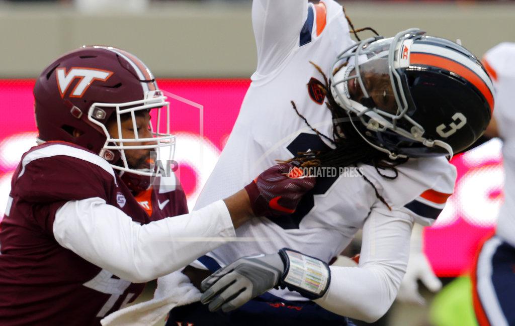 Steve Helber Virginia linebacker Reed Kellam, left, grabs the hair of Virginia quarterback Bryce Perkins (3) as he sacks him during the first half of an NCAA college football game in Blacksburg, Va., Friday, Nov. 23, 2018. (AP Photo/Steve Helber)