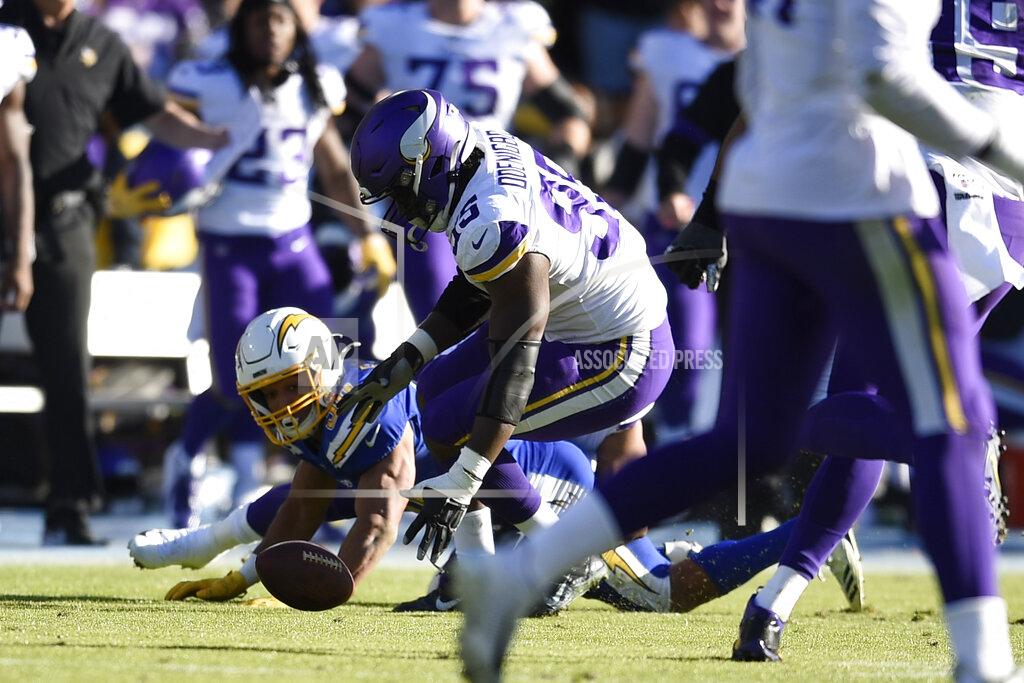 Kelvin Kuo Minnesota Vikings defensive end Ifeadi Odenigbo, center, picks up a fumble before running it back for a touchdown during the first half of an NFL football game against the Los Angeles Chargers, Sunday, Dec. 15, 2019, in Carson, Calif. (AP Photo/Kelvin Kuo)