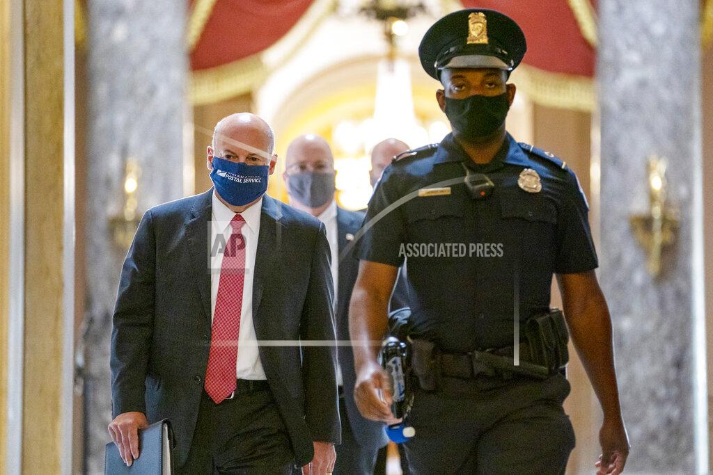 Carolyn Kaster Postmaster General Louis DeJoy, left, is escorted to House Speaker Nancy Pelosi's office on Capitol Hill in Washington, Wednesday, Aug. 5, 2020. Some clarity is beginning to emerge from the bipartisan Washington talks on a huge COVID-19 response bill. An exchange of offers and meeting devoted to the Postal Service on Wednesday indicates the White House is moving slightly in House Speaker Nancy Pelosi's direction on issues like aid to states and local governments and unemployment insurance benefits. But the negotiations have a long ways to go. (AP Photo/Carolyn Kaster)