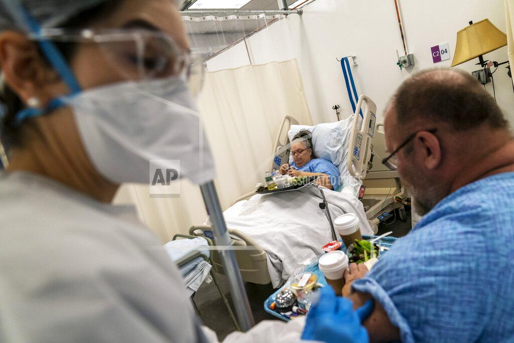David Goldman Peter Sorrow, 62, right, receives an injection of medicine from registered nurse Naomi Barnum, while sharing the "honeymoon suite" with his wife, Pauline, 71, as they both recover from COVID-19 at a field hospital set up to handle a surge of COVID-19 patients, Wednesday, Feb. 10, 2021, in Cranston, R.I. While both are steadily recovering, Pauline worries that COVID-19 still could take both of them. "I kind of wonder sometimes if we're going to wake up and we won't be here," she said. (AP Photo/David Goldman)