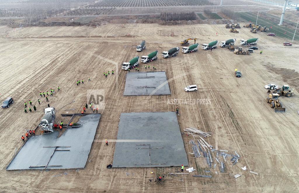 Yang Shiyao In this photo released by China's Xinhua News Agency, workers begin to build a medical isolation site that, according to state media, will cover 33 hectares and have room for several thousand people in Shijiazhuang in northern China's Hebei Province, Thursday, Jan. 14, 2021. China has put more than 20 million people under varying degrees of lockdown in Hebei, Beijing and other areas in hopes of stemming infections ahead of next month's Lunar New Year holiday. (Yang Shiyao/Xinhua via AP)