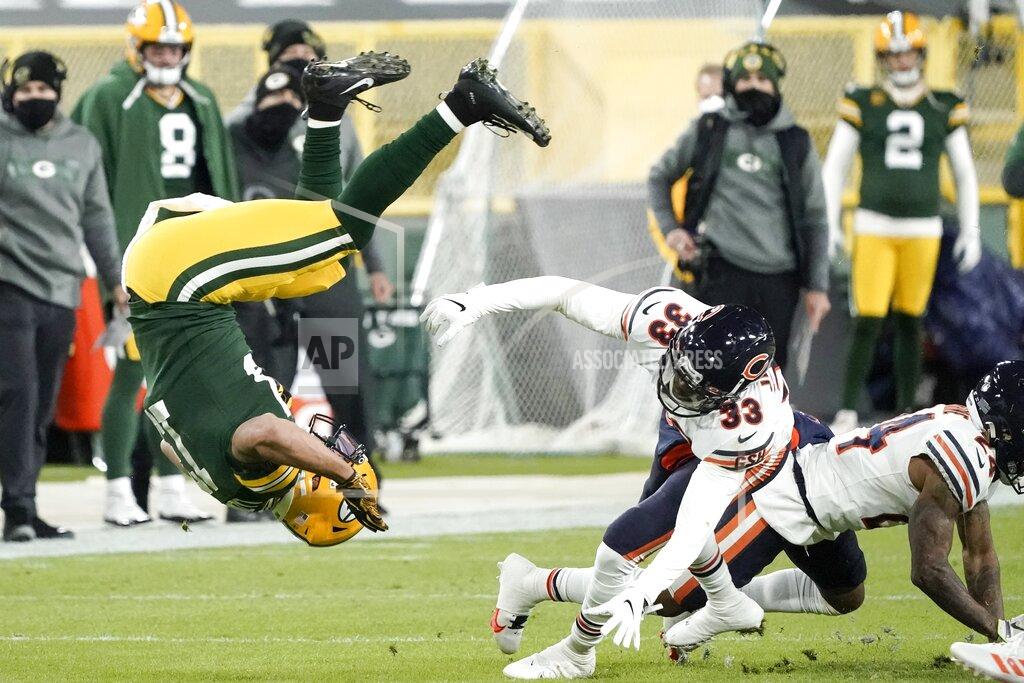 Morry Gash Green Bay Packers' Aaron Jones is tripped up by Chicago Bears' Jaylon Johnson after catching a pass during the first half of an NFL football game Sunday, Nov. 29, 2020, in Green Bay, Wis. (AP Photo/Morry Gash)
