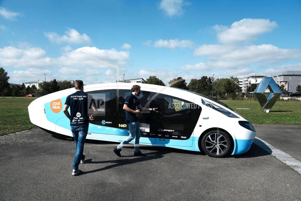 Thibault Camus The solar-powered vehicle is on display on a closed road, in Guyancourt, south of Paris, Friday Sept. 24, 2021. A group of Dutch students has reimagined van life and is hitting the road to Portugal. Just don't call their groundbreaking new solar-powered vehicle a campervan. (AP Photo/Thibault Camus)