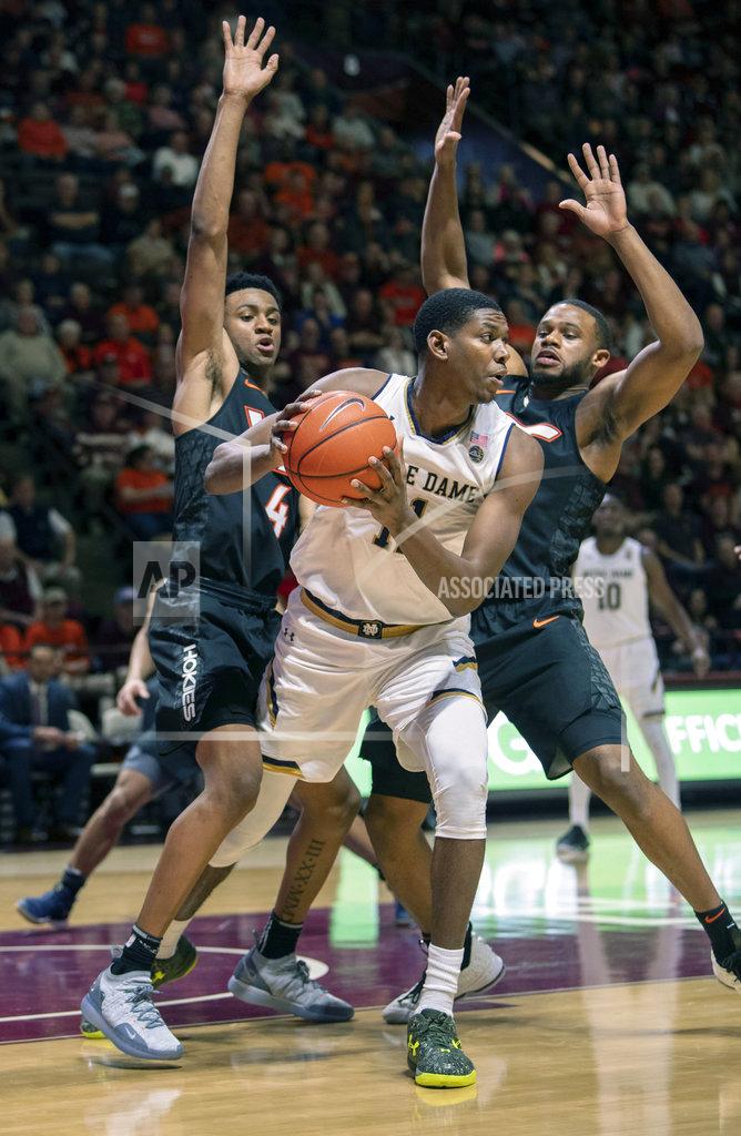 Don Petersen Virginia Tech guard Nickeil Alexander-Walker (4) and Virginia Tech forward P.J. Horne (14) defend against Notre Dame forward Juwan Durham (11) during the first half of an NCAA college basketball game Tuesday, Jan. 1, 2019, in Blacksburg, Va. (AP Photo/Don Petersen)