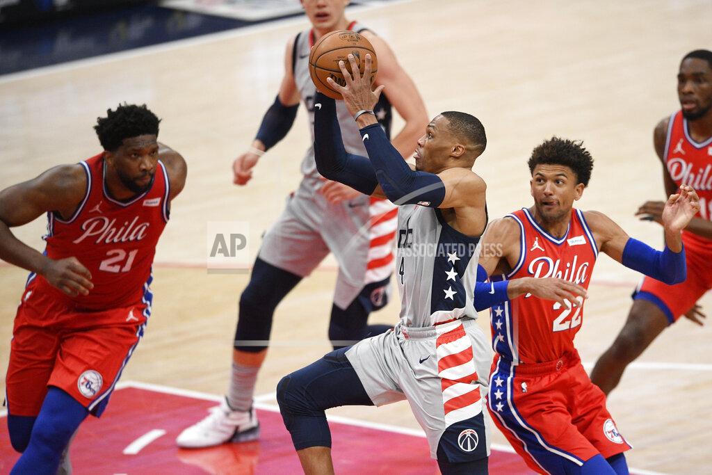 Nick Wass Washington Wizards guard Russell Westbrook (4) goes to the basket against Philadelphia 76ers center Joel Embiid (21) and guard Matisse Thybulle (22) during the first half of an NBA basketball game Friday, March 12, 2021, in Washington. (AP Photo/Nick Wass)