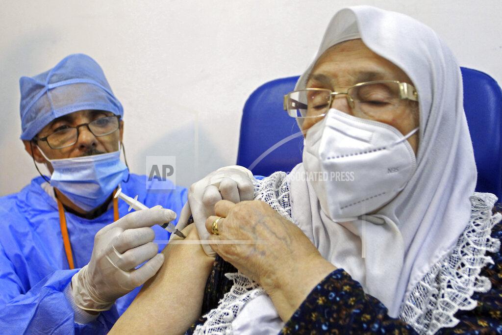 Fateh Guidoum A woman receives the Sputnik-V COVID-19 vaccine at a vaccination center in Blida, south of Algiers, Algeria, Saturday, Jan. 30, 2021. The vaccines were delivered to the Boufarik military airport west of Algiers, Minister Amar Belhimeur said in a statement. He did not indicate how many arrived, though the government had said it had ordered a first batch of 500,000 Sputnik doses. (AP Photo/Fateh Guidoum)