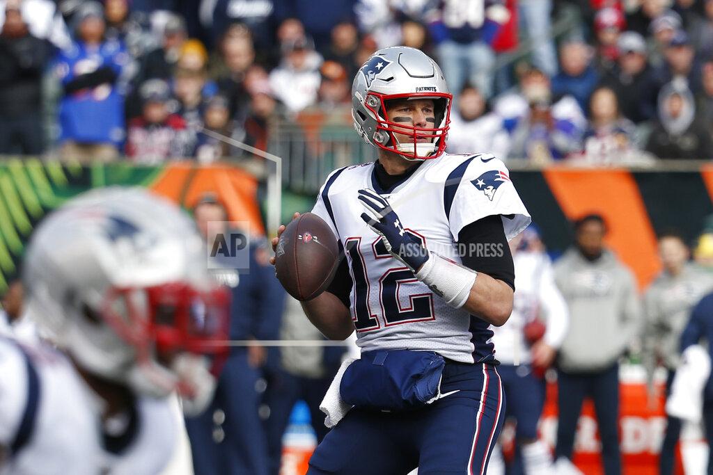 Frank Victores New England Patriots quarterback Tom Brady (12) looks to pass before throwing for a touchdown in the first half of an NFL football game against the Cincinnati Bengals, Sunday, Dec. 15, 2019, in Cincinnati. With this touchdown pass Brady surpasses Peyton Manning for the most seasons with 20+ touchdown passes in NFL history. (AP Photo/Frank Victores)
