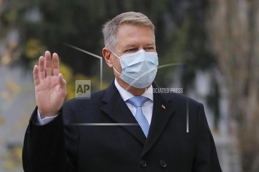 Vadim Ghirda Romanian President Klaus Iohannis wearing a mask for protection against the COVID-19 infection waves as he arrives at a voting station in Bucharest, Romania, Sunday, Dec. 6, 2020. Voting started in Romania's legislative election expected to restore some measure of stability after five years of political and social turbulence with more than 18 million Romanians registered to vote for a new legislative body. (AP Photo/Vadim Ghirda)
