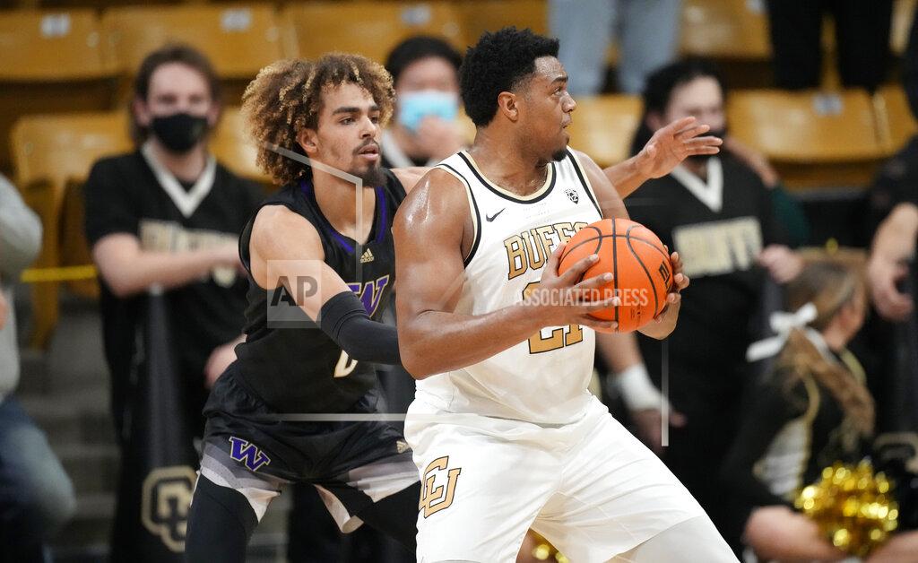 David Zalubowski Colorado forward Evan Battey, front, looks to drive the lane as Washington forward Emmitt Matthews Jr. defends in the first first half of an NCAA college basketball game Sunday, Jan. 9, 2022, in Boulder, Colo. (AP Photo/David Zalubowski)