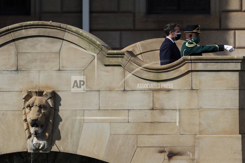 Themba Hadebe French President Emmanuel Macron reviews the honour guard during a welcoming ceremony at the government's Union Buildings, in Pretoria, South Africa, Friday, May 28, 2021. Macron is on a two-day official visit to the country. (AP Photo/Themba Hadebe, Pool)