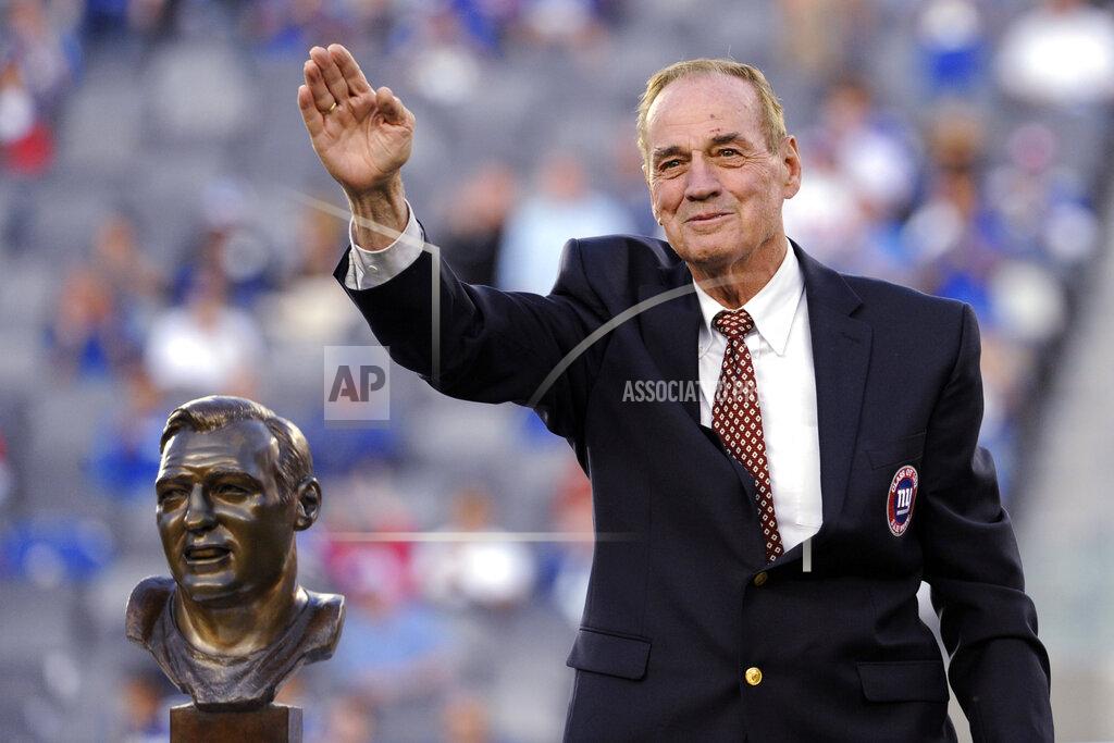 Bill Kostroun FILE - Former New York Giants linebacker Sam Huff waves to the fans as he stands behind his Hall of Fame bust during the halftime show of an NFL football game between the Giants and the Denver Broncos on Sept. 15, 2013, in East Rutherford, N.J. Huff, the hard-hitting Hall of Fame linebacker who helped the Giants reach six NFL title games from the mid-1950s to the early 1960s and later became a popular player and announcer in Washington, died Saturday, Nov. 13, 2021. He was 87. (AP Photo/Bill Kostroun File)