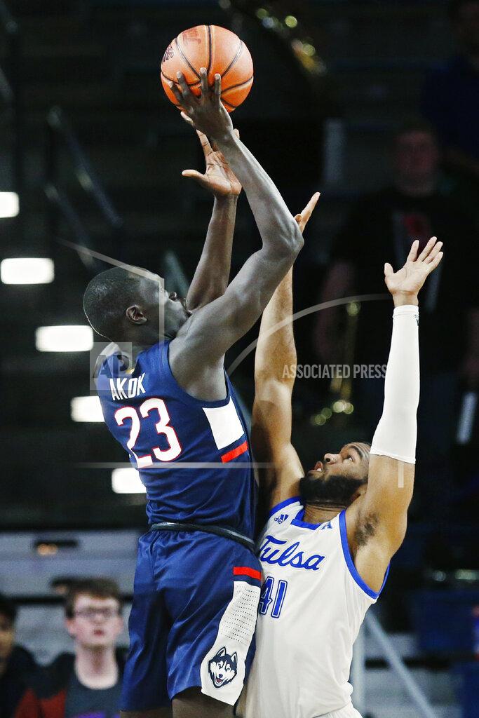 Sue Ogrocki Connecticut forward Akok Akok (23) shoots over Tulsa forward Jeriah Horne (41) during the second half of an NCAA college basketball game in Tulsa, Okla., Thursday, Feb. 6, 2020. (AP Photo/Sue Ogrocki)