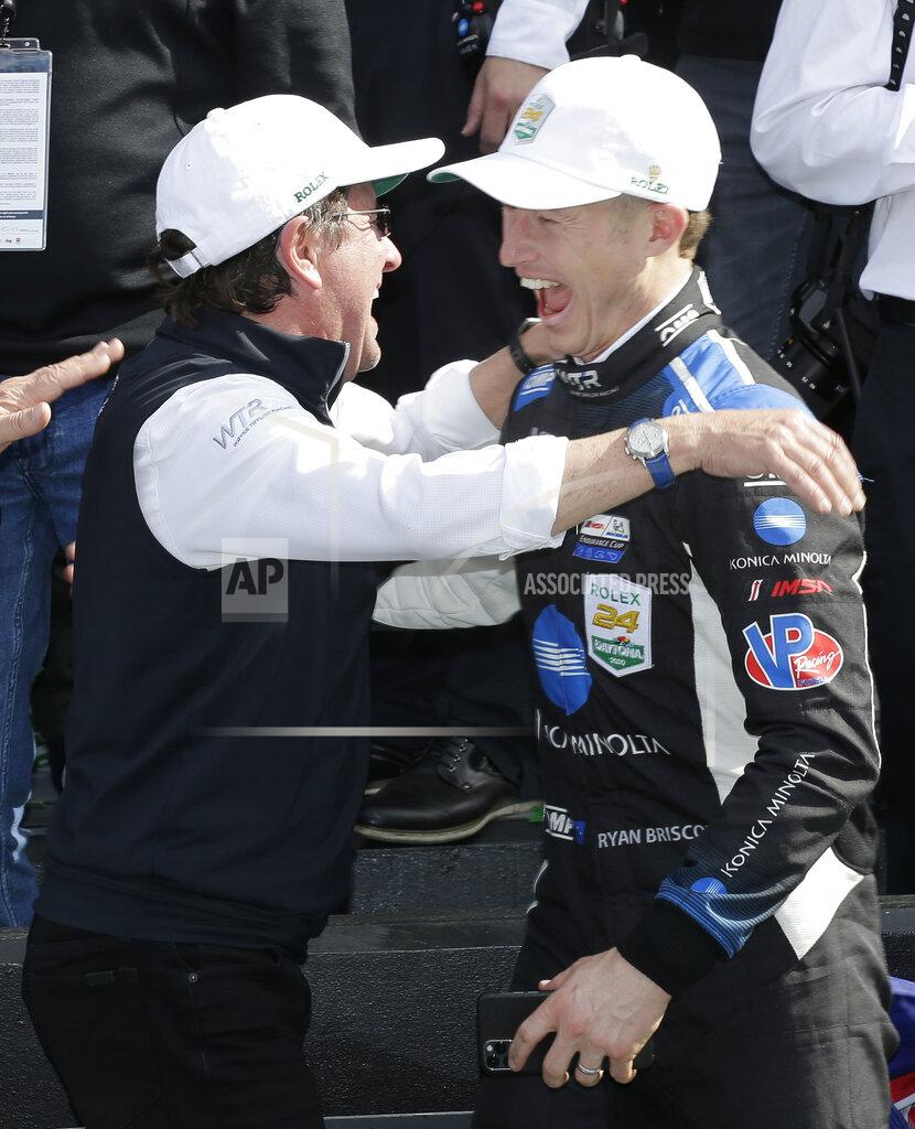 Terry Renna Konica Minolta Cadillac DPi-V.R driver Ryan Briscoe, right, and team owner Wayne Taylor, left, celebrate in Victory Lane after winning the Rolex 24-hour auto race at Daytona International Speedway, Sunday, Jan. 26, 2020, in Daytona Beach, Fla. (AP Photo/Terry Renna)