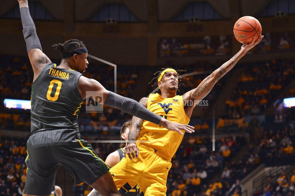 William Wotring West Virginia forward Jalen Bridges (11) attempts a shot while being guarded by Baylor forward Flo Thamba (0) during the first half of an NCAA college basketball game in Morgantown, W.Va., Tuesday, Jan. 18, 2022. (William Wotring)