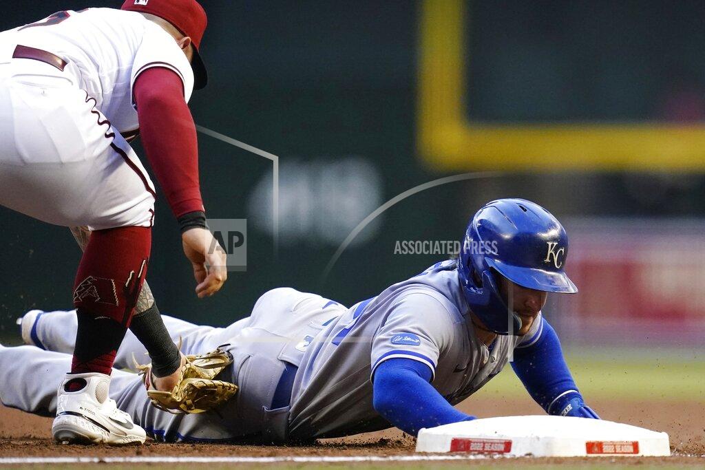 Ross D. Franklin Kansas City Royals' Kyle Isbel, right, dives safely back to first base as Arizona Diamondbacks first baseman Christian Walker, left, applies a late tag during the first inning of a baseball game Monday, May 23, 2022, in Phoenix. (AP Photo/Ross D. Franklin)