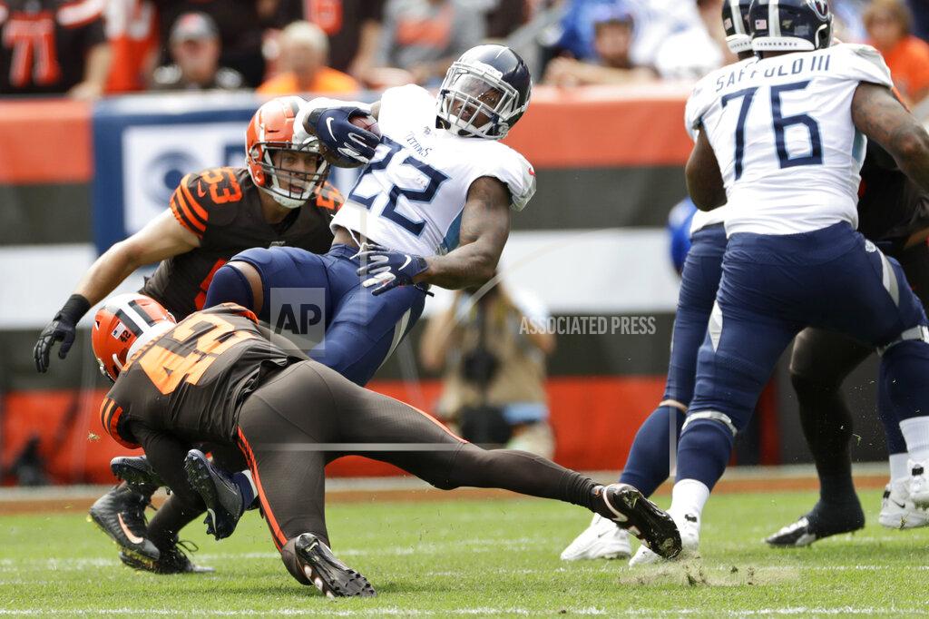 Ron Schwane Cleveland Browns strong safety Morgan Burnett (42) trips up Tennessee Titans running back Derrick Henry (22) for a one-yard loss during the first half in an NFL football game, Sunday, Sept. 8, 2019, in Cleveland. (AP Photo/Ron Schwane)