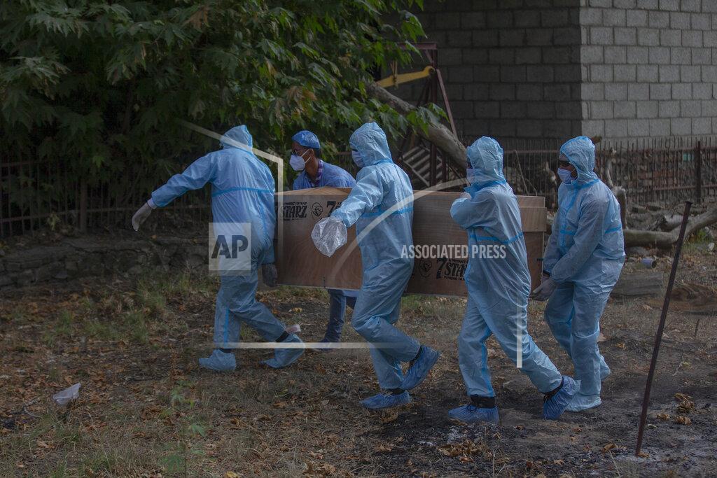 Dar Yasin Indian paramilitary soldiers carry the body of a colleague who died of COVID-19 for cremation at a crematorium in Srinagar, Indian controlled Kashmir, Saturday, July 18, 2020. India crossed 1 million coronavirus cases on Friday, third only to the United States and Brazil, prompting concerns about its readiness to confront an inevitable surge that could overwhelm hospitals and test the country's feeble health care system. (AP Photo/ Dar Yasin)