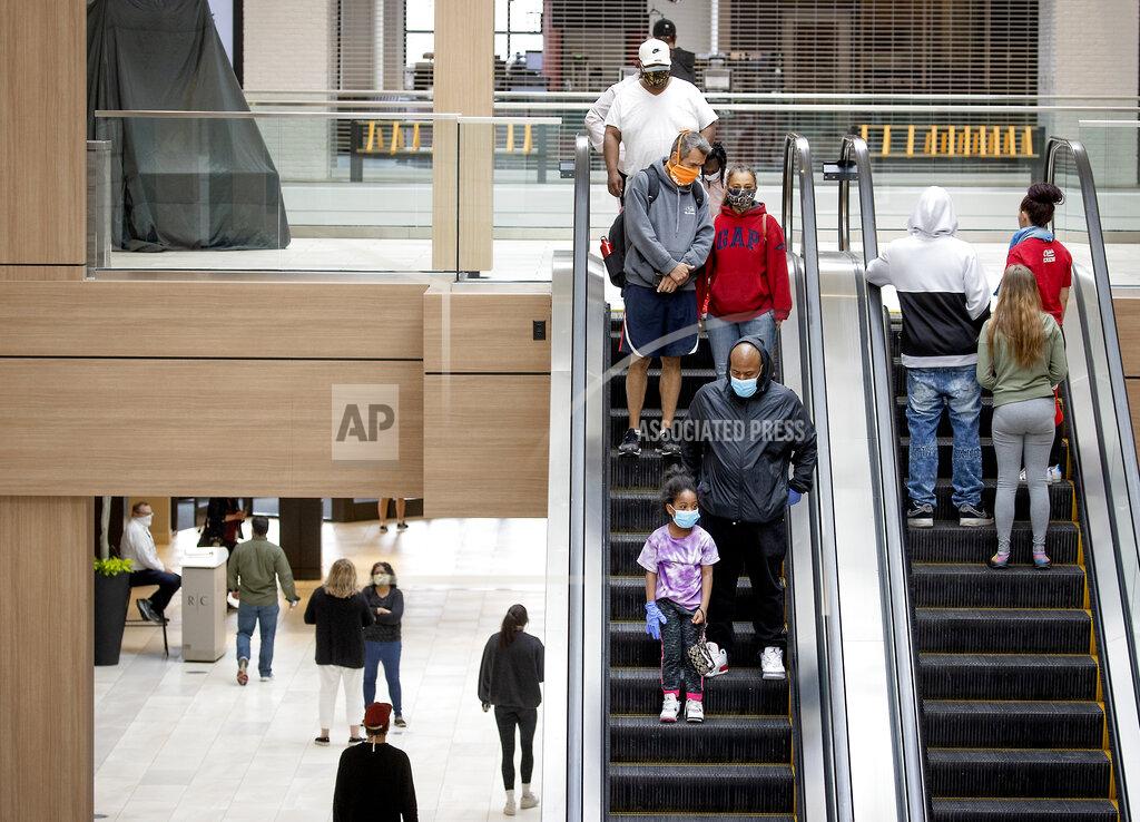 Elizabeth Flores Shoppers made their way through Rosedale Center as some of the stores opened for business during the coronavirus pandemic, Monday, May 18, 2020 in Roseville, Minn. (Elizabeth Flores/Star Tribune via AP)