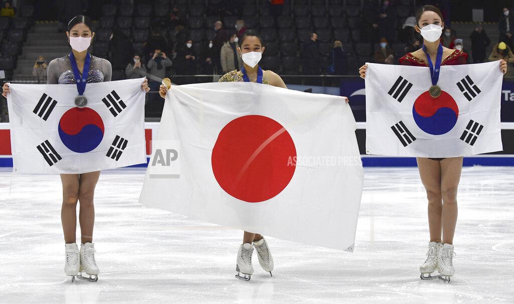 Sergei Stepanov Mai Mihara of Japan, centre, first placed, Haein Lee of South Korea, second placed, left, Yelim Kim of South Korea, who finished third, pose with state flags after the women free skating program during the ISU Four Continents Figure Skating Championships in Tallinn, Estonia, Saturday, Jan. 22, 2022. (AP Photo/Sergei Stepanov)