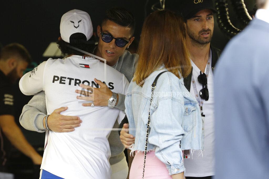 Luca Bruno Mercedes driver Lewis Hamilton of Britain, left, welcomes Cristiano Ronaldo at the pit line ahead of the second practice session at the Monaco racetrack, in Monaco, Thursday, May 23, 2019. The Formula one race will be held on Sunday. (AP Photo/Luca Bruno)