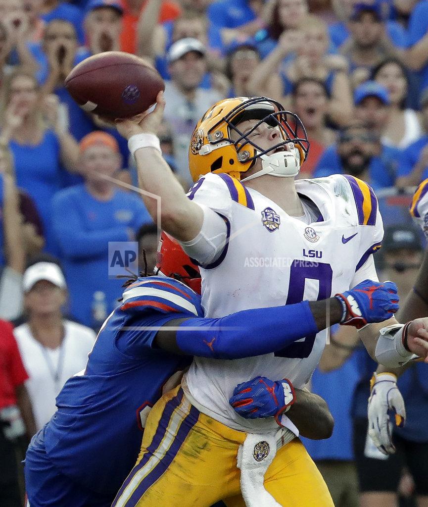 John Raoux Florida defensive lineman Jachai Polite, left, hits LSU quarterback Joe Burrow just as he releases a pass during the second half of an NCAA college football game Saturday, Oct. 6, 2018, in Gainesville, Fla. (AP Photo/John Raoux)