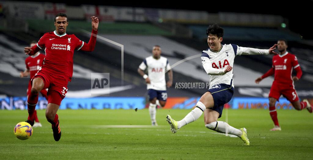 Tottenham's Son Heung-min, right, shoots on goal during the English Premier League soccer match between Tottenham Hotspur and Liverpool at the Tottenham Hotspur Stadium in London, Thursday, Jan. 28, 2021. (Nick Potts/Pool via AP)
