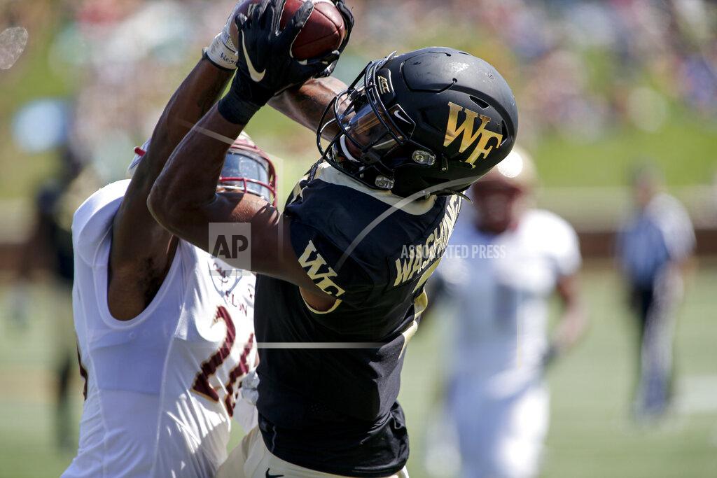 Nell Redmond Wake Forest wide receiver Scotty Washington, right, catches a 31-yard touchdown pass against Elon defensive back Daniel Reid-Bennett in the second half of an NCAA college football game in Winston-Salem, N.C., Saturday, Sept. 21, 2019. Wake Forest won 49-7. (AP Photo/Nell Redmond)